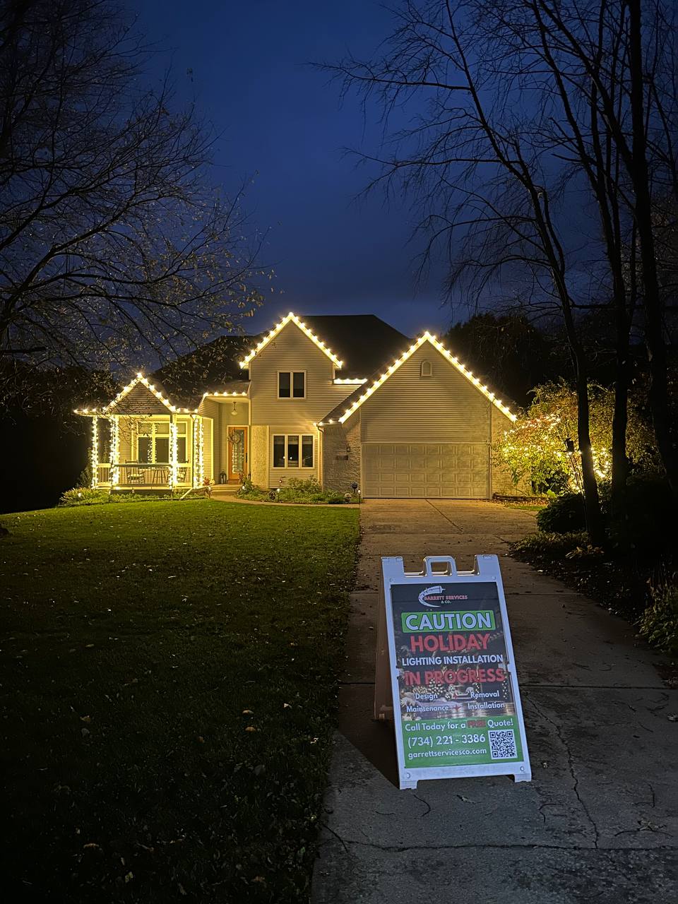 Colorful Christmas lights decorating the roofline of a residential home